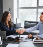 Bonnie Huggins shaking client's hand during financial audit.